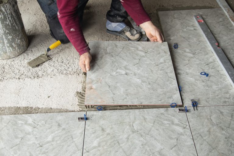 Laying floor ceramic tile. Renovating the floor